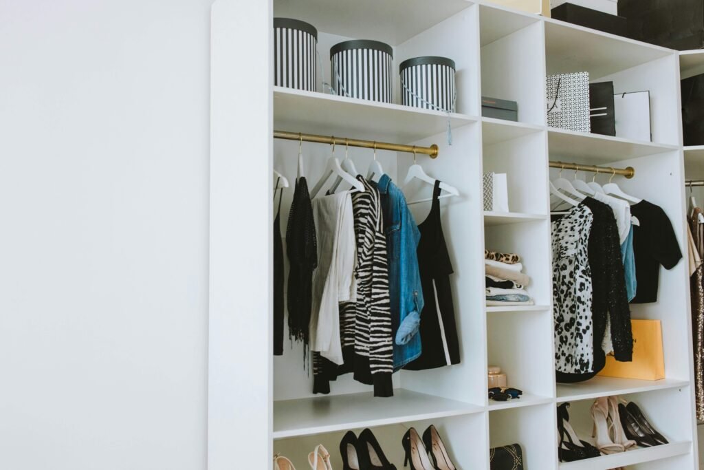 Your Closet Makeover (Plus a free checklist) 1 Neatly arranged wardrobe showcasing stylish clothes and shoes indoors.